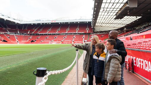 A family look out towards the pitch during a stadium tour