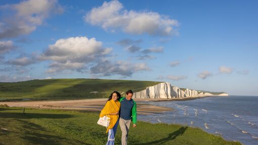 A couple hiking along the Seven Sisters cliffs in Seaford