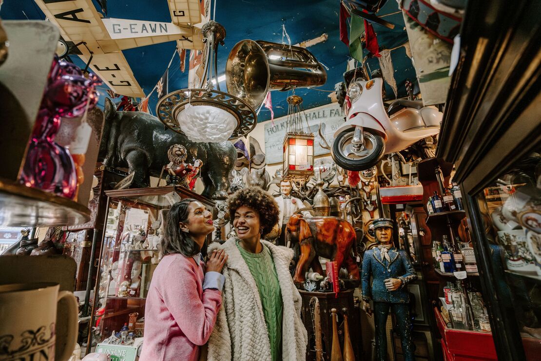 Two women exploring an antique shop in London