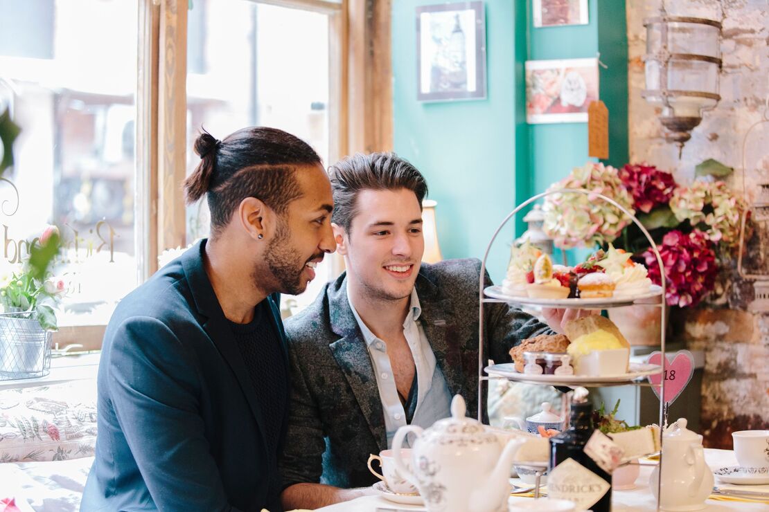 Two men enjoying afternoon tea in a traditional tea room