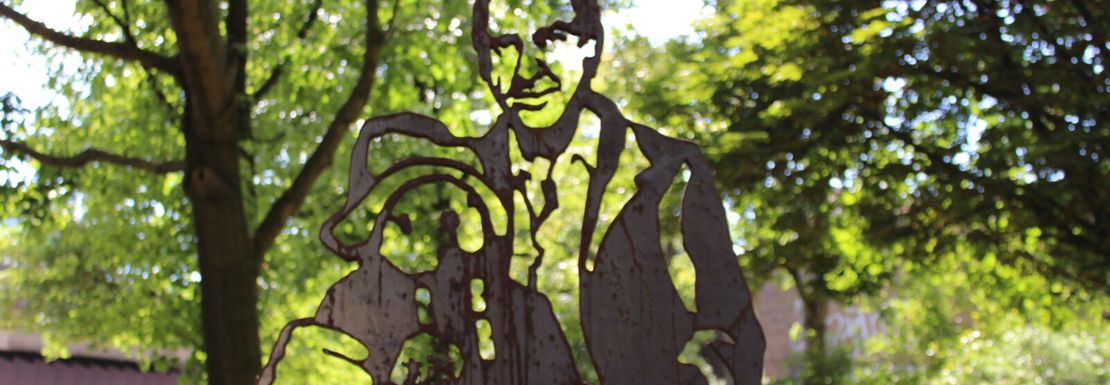 Paddington black outlay over a green London park background.