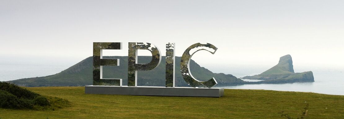 A giant sign saying 'Epic' stands on a beautiful plateau