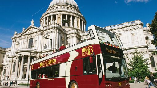 People enjoying an open top bus excursion exploring the city sights