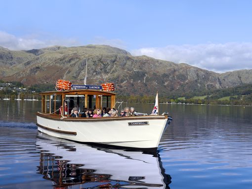 Passengers admiring the views over the Lake District hills from Coniston Water