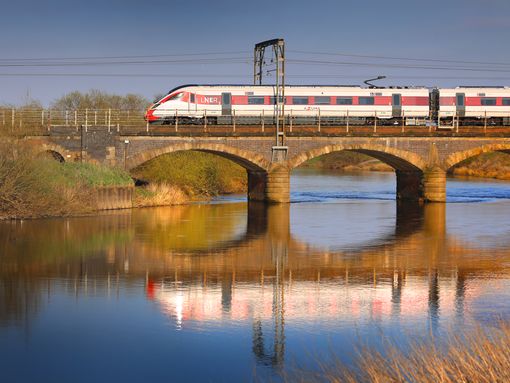 A train over a bridge near Newark you can board with a BritRail Euro GB M-Pass