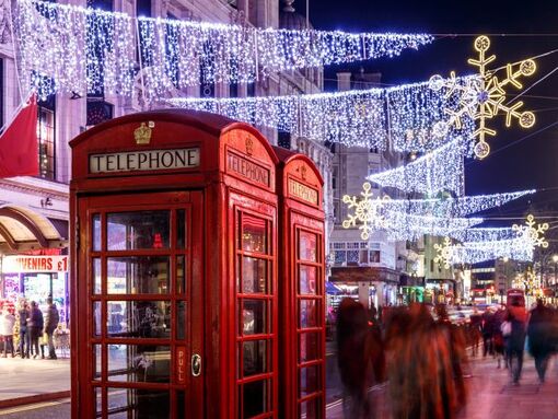 Red telephone boxes illuminated by Christmas lights