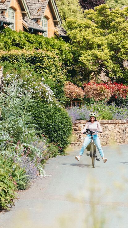 A couple cycling through the Cotswolds