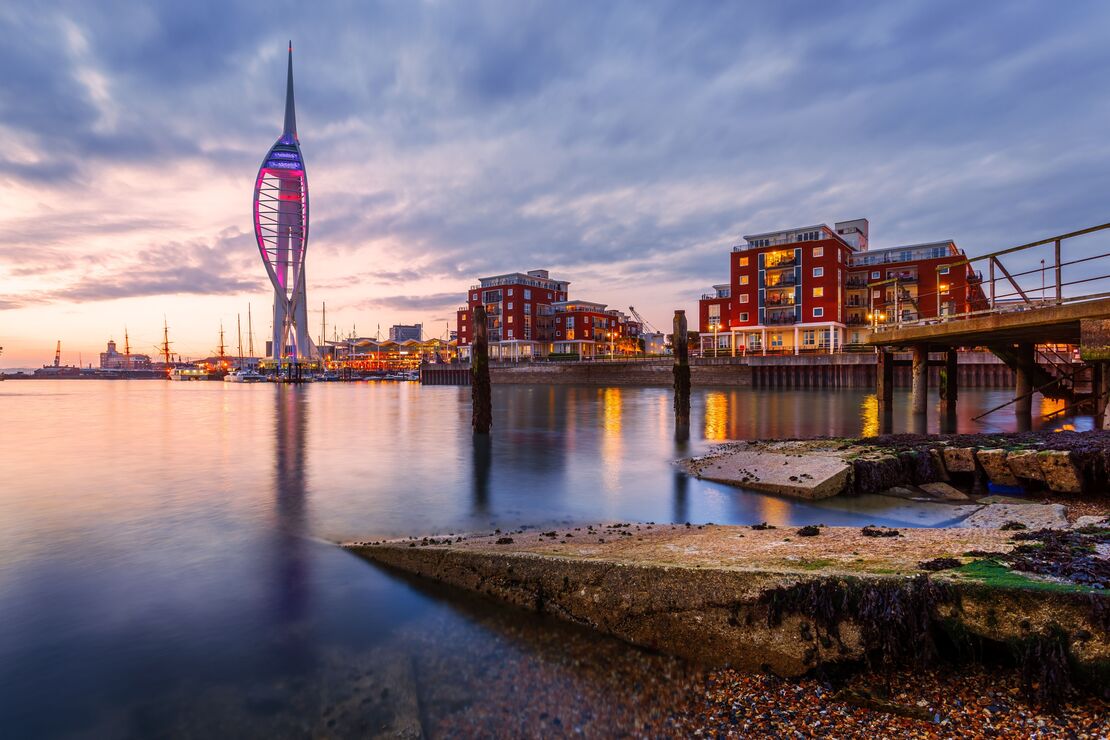 Portsmouth Harbour with Spinnaker Tower lit up at dusk