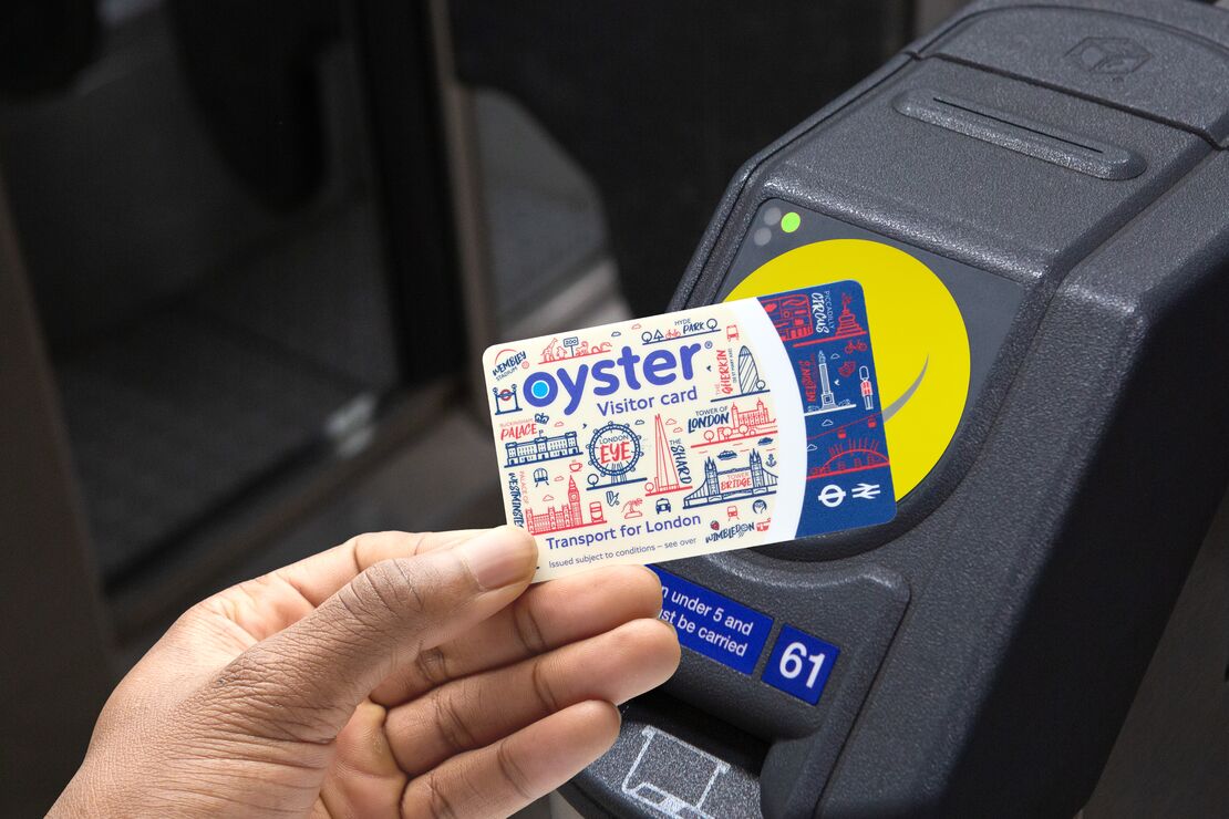 A tourist tapping their Visitor Oyster card on the turnstile