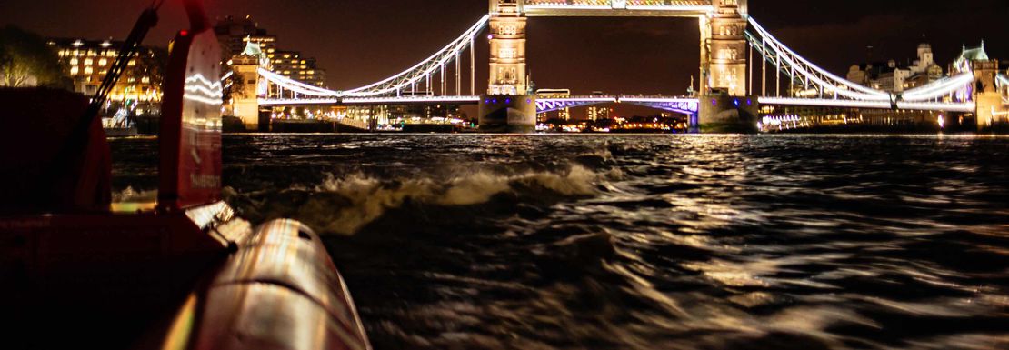view_of_the_tower_bridge_at_night_from_a_thames_rocket_speedboat