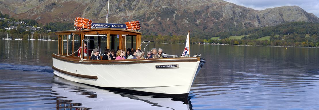 Passengers admiring the views over the Lake District hills from Coniston Water