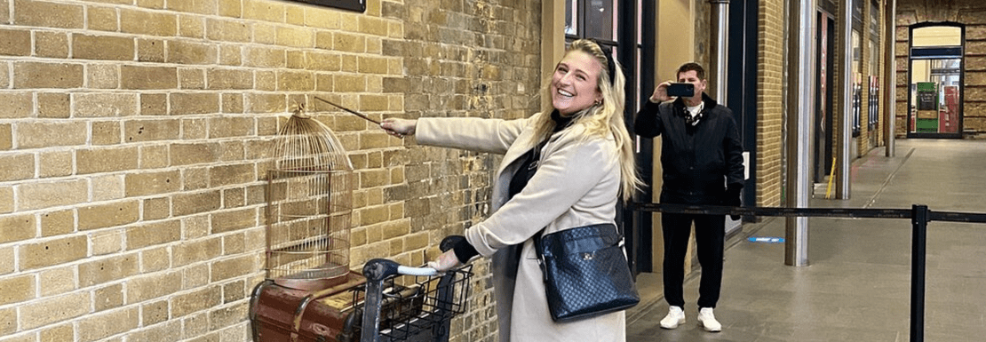 Tour member holding trolley at Platform 9 3/4