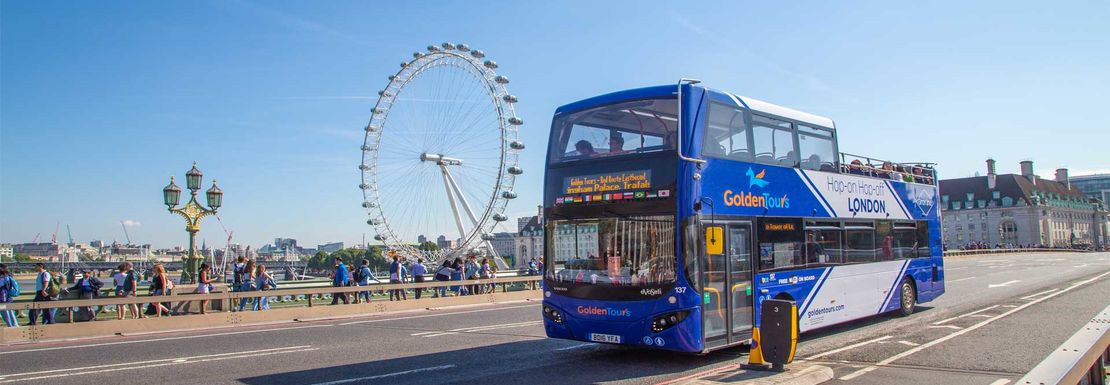 The Hop on hop off London Bus Tour at Westminster Bridge with the London Eye at the background