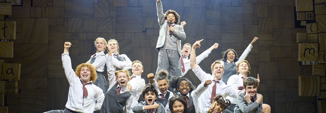 The children in Matilda the Musical hold their pose as they entertain the audience