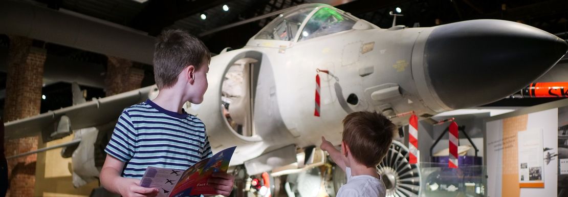 Two young boys enjoy the sight of a sea harrier at the Aerospace Bristol museum