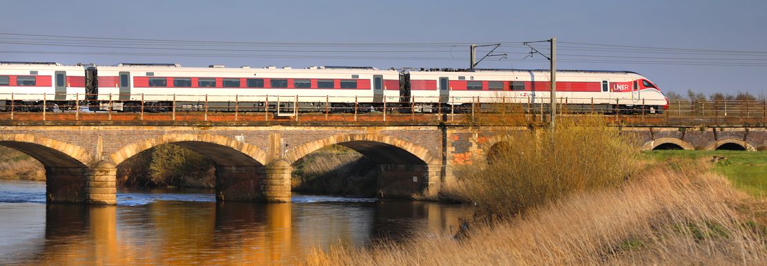 A train over a bridge near Newark you can board with a BritRail Euro GB M-Pass