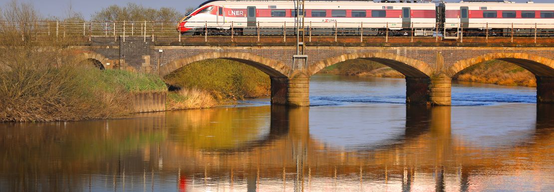 A train over a bridge near Newark you can board with a BritRail Euro GB M-Pass
