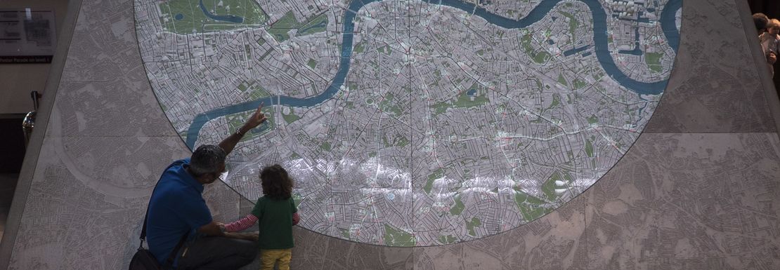 A father and his son checkng the TfL Underground map at the London Transport Museum