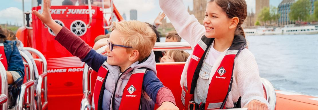 Children enjoy the speed and thrills of a speedboat on the Thames in London