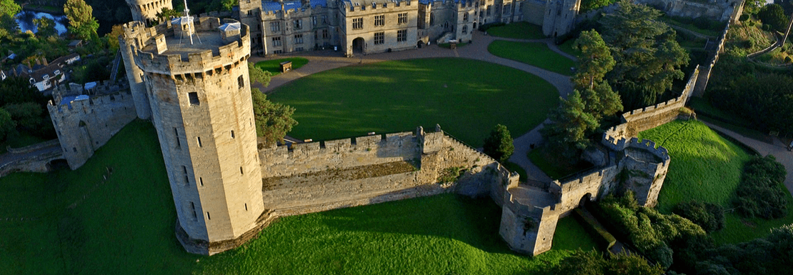 The tower of Warwick Castle stands in its lovely natural surroundings