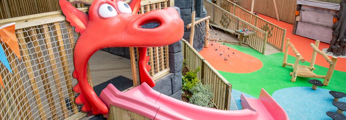 Warwick Castle's Zog slide stands above a fun play area for children