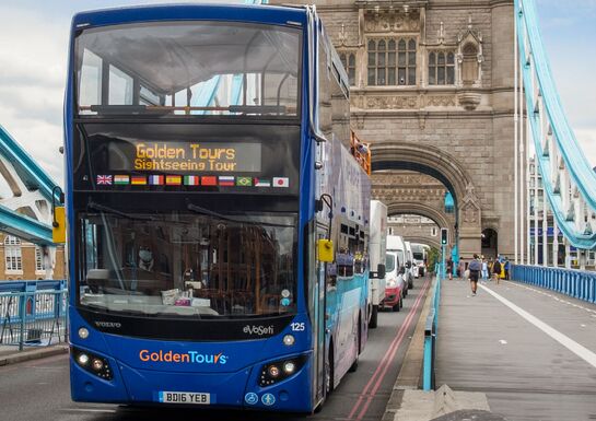 The Golden Tours tour bus crosses Tower Bridge on its tour for visitors to London