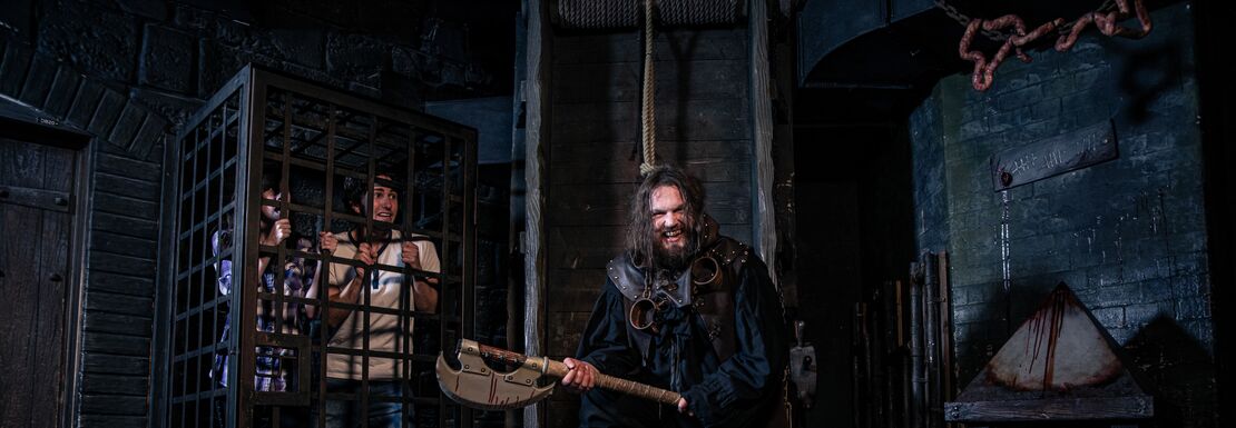 A group of visitors take part in an executioner's terror at the London Dungeon