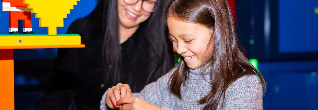 A mother and daughter creating at Christmas at the LEGOLAND® Discovery Centre Birmingham