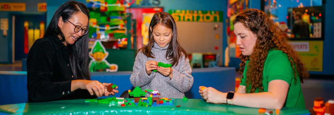 A family playing with festive LEGO at the LEGOLAND® Discovery Centre Birmingham
