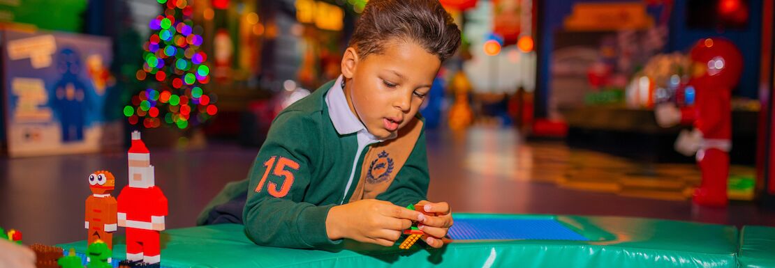 A child making festive LEGO creations at the LEGOLAND® Discovery Centre Birmingham