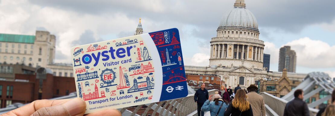 A Visitor Oyster Card is held up against the background of St Paul's Cathedral