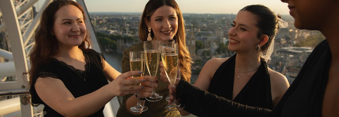 A group of friends drinking champagne in the London Eye